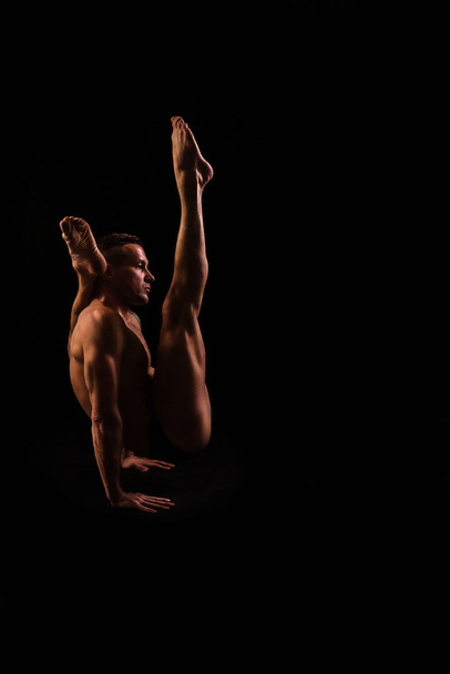 young man doing yoga and gymnastics, strength training - Photo, Image
