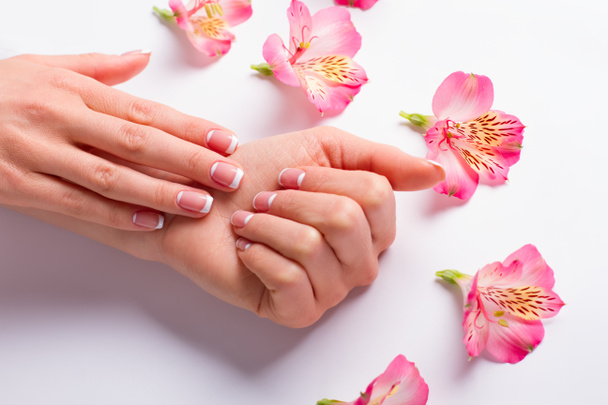 Female hand with delicate flowers. - Photo, Image