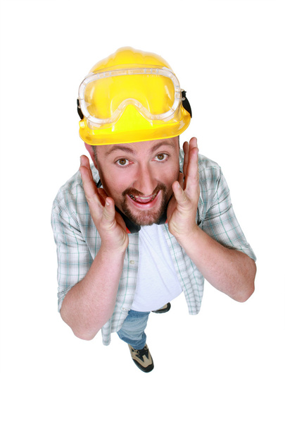 Goofy tradesman putting his hands along his face - Photo, Image