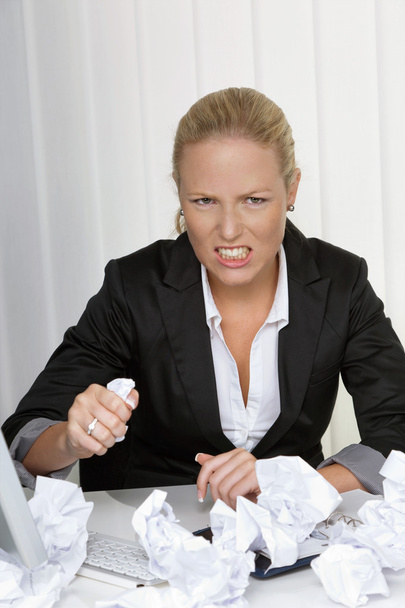 woman in office with crumpled paper - Фото, изображение
