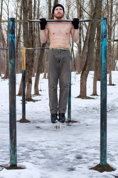  man with naked torso doing street workout - Photo, Image