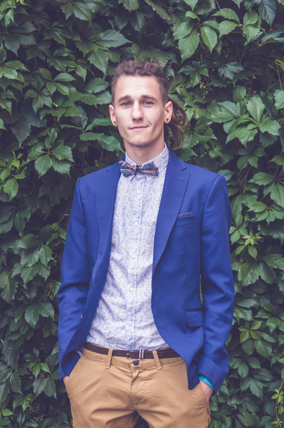 A young man in a jacket and bow tie - Фото, изображение