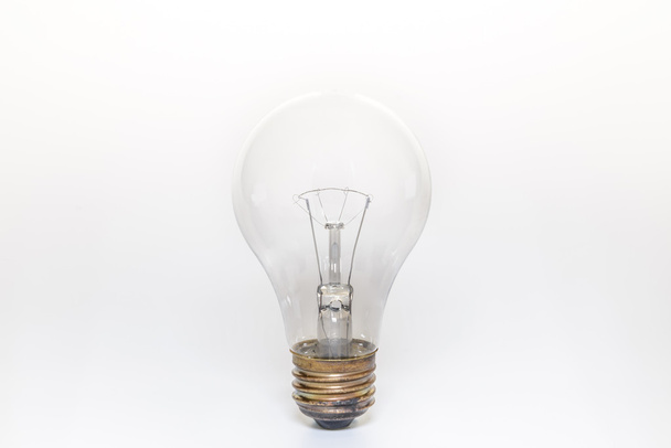 Única lâmpada no fundo branco
 - Foto, Imagem