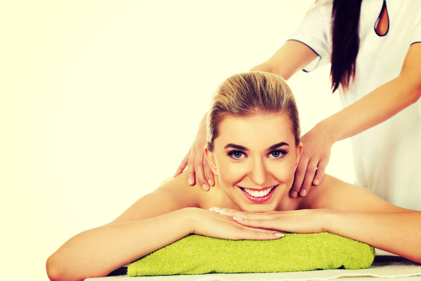 Young smile woman lying on a massage table and has massage. - Photo, Image