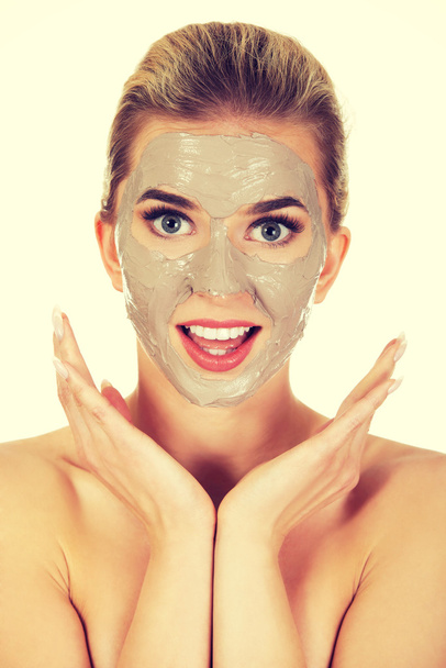 Young happy woman with facial mask. - Foto, imagen