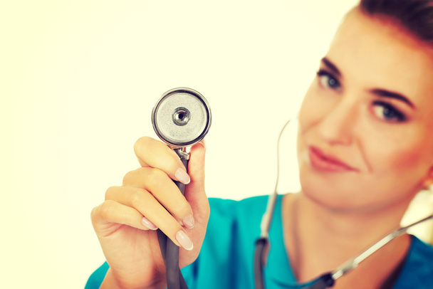 Smiling female doctor holding a stethoscope - Foto, Imagen