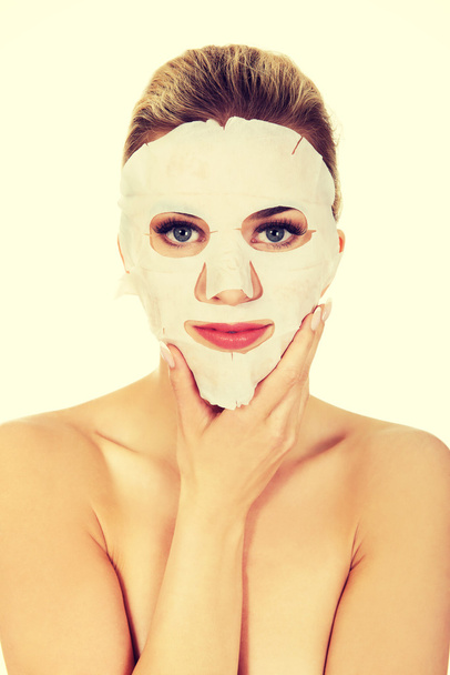 Young woman with facial mask - Foto, imagen