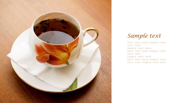 Porcelain teacup and saucer on a wooden table - Zdjęcie, obraz