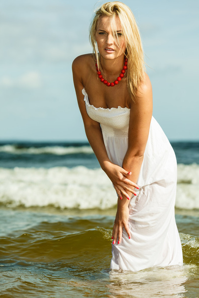 Beautiful blonde girl on beach, summertime - Photo, Image