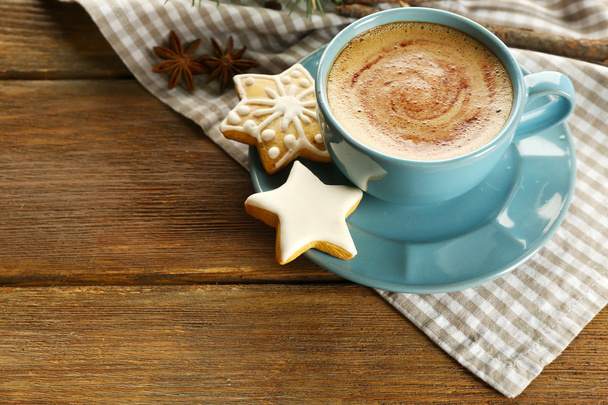 Cup of coffee with star shaped biscuits and Christmas tree branch on napkin - Fotografie, Obrázek