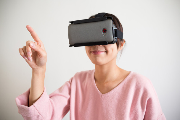 vrouw met behulp van virtuele realiteit apparaat - Foto, afbeelding