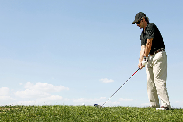 Golfer shooting a golf ball - Fotó, kép