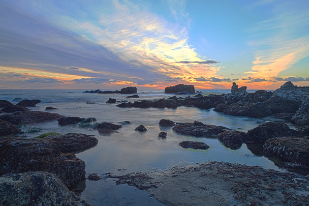 Long exposure of sunset over rocks - Photo, Image