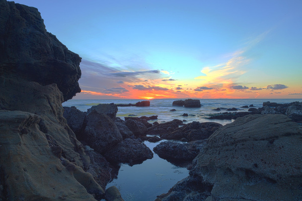 Long exposure of sunset over rocks - Photo, Image