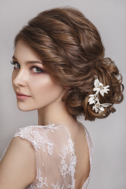 Beautiful bride with fashion wedding hairstyle - on white background.Closeup portrait of young gorgeous bride. Wedding. Studio shot. Beautiful bride portrait - Фото, зображення