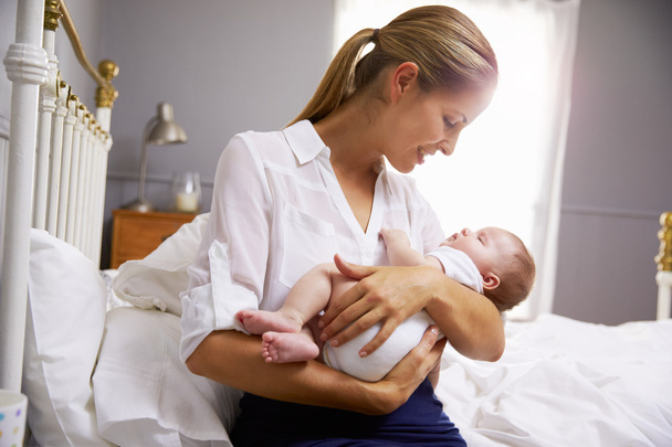 Mother Holding Baby In Bedroom - Foto, Imagen
