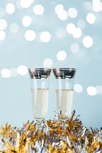 Champagne glasses on sparkling background - Valokuva, kuva