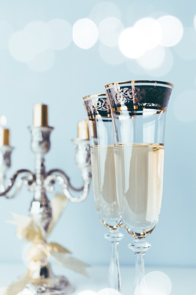 Champagne glasses on sparkling background - Fotó, kép