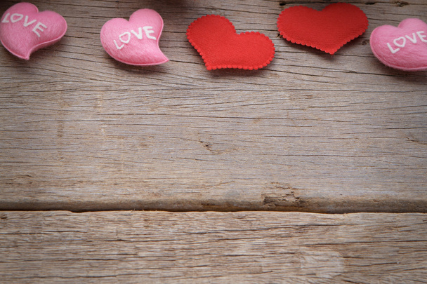 Valentines day background with red and pink hearts on wooden background. - Photo, image
