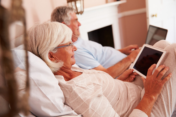 Senior Couple Using Digital Devices - Фото, изображение