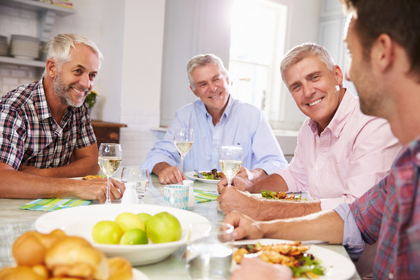 Mature Friends Enjoying Meal At Home - Photo, Image