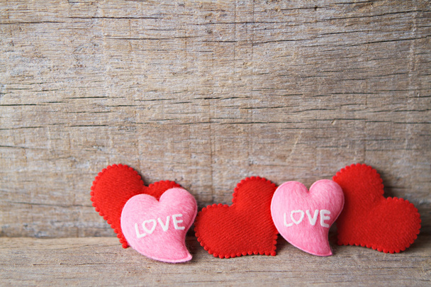 Valentines day background with red and pink hearts on wooden background. - Photo, Image