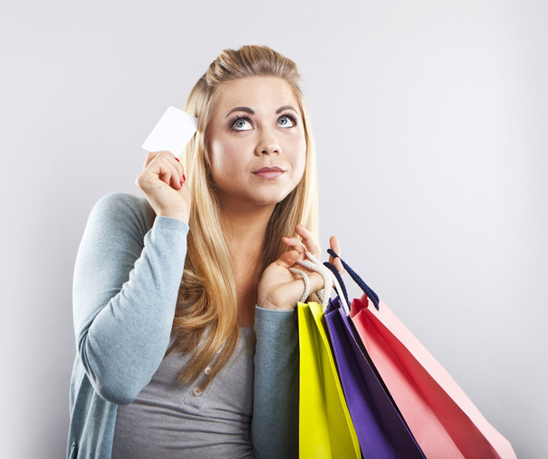 Happy blonde woman hold shopping bag. Shopping with credit card. Smiling girl - Photo, Image