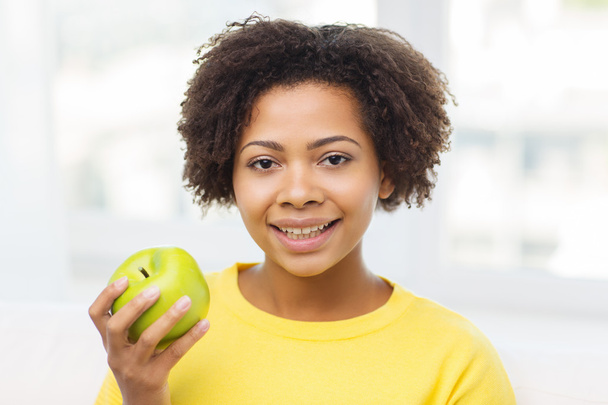 happy african american woman with green apple - Foto, Imagen