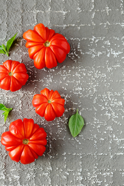  tomatoes on cement background - Zdjęcie, obraz