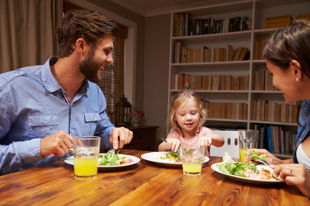 Family eating dinner at a dining table - Photo, Image
