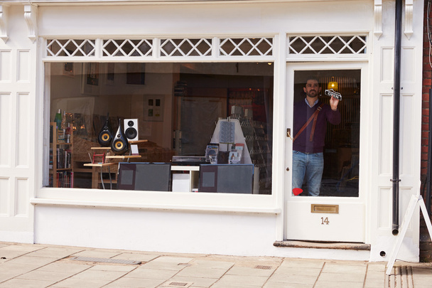 Shop owner opening up hi-fi shop - Foto, Imagen
