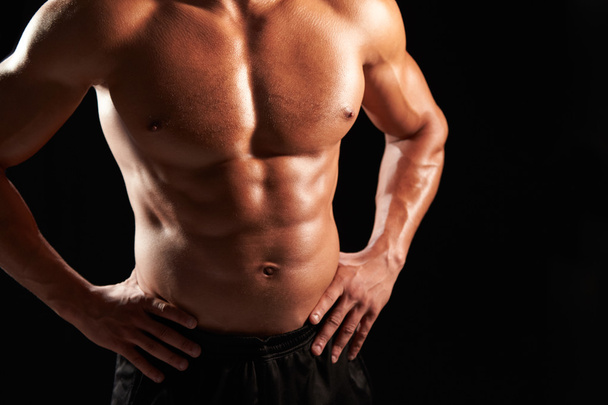 Male bodybuilder with hands on hips - Фото, зображення