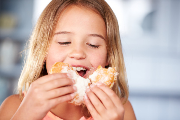 Girl Sitting Eating Sugary Donut - Fotoğraf, Görsel