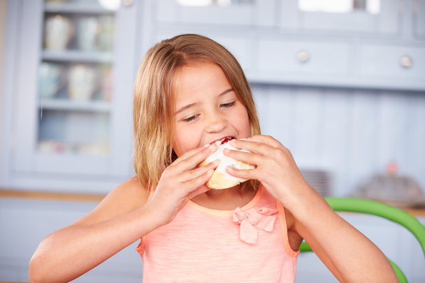 Girl  Eating Sugary Iced Bun - Foto, Imagem