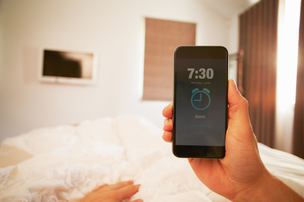 Person In Bed Turning Off Phone Alarm - Foto, imagen