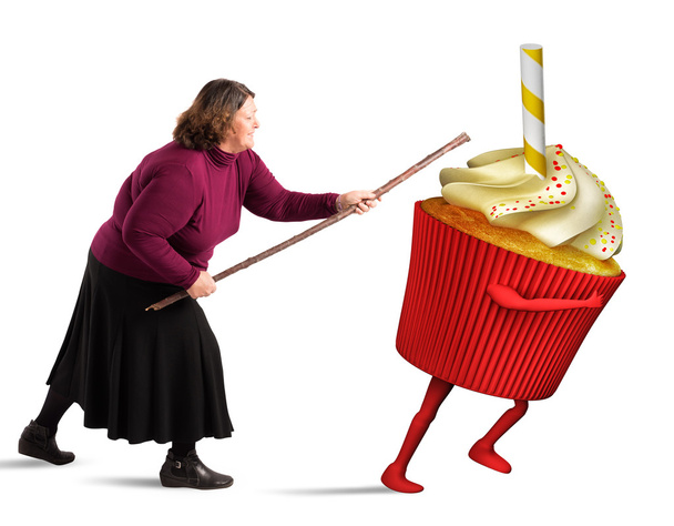 Fat woman hiting a cupcake with stick - Photo, Image