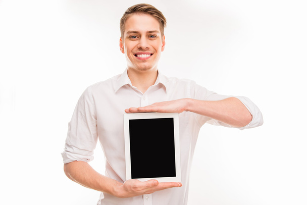 Handsome happy young man holding digital tablet - Фото, изображение