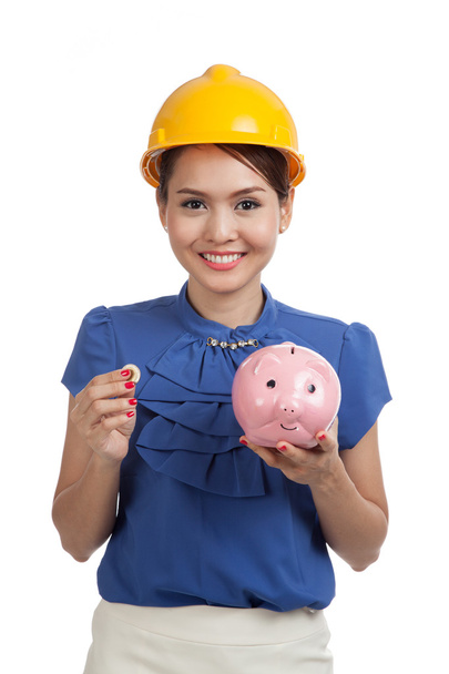 Asian engineer woman with a coin and piggy coin bank - Fotoğraf, Görsel