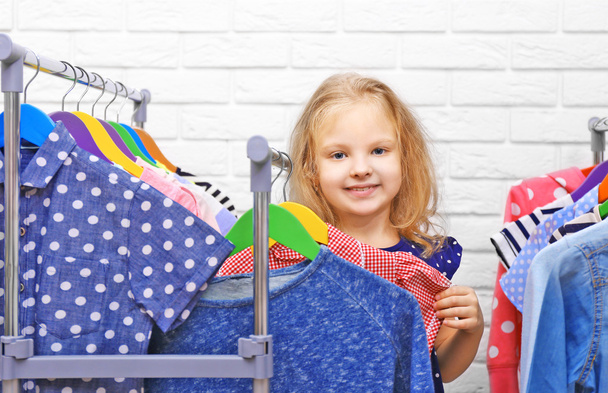 Little girl trying on clothes - Фото, зображення