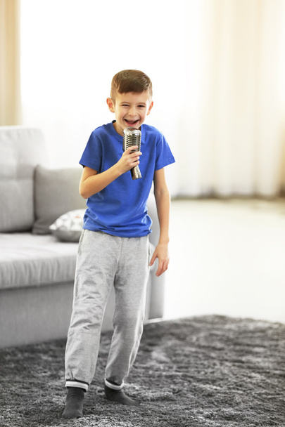 Little boy singing with microphone  - Fotografie, Obrázek