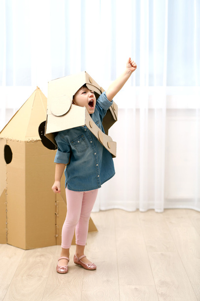 Girl playing with cardboard space rocket - Photo, Image