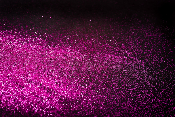 Pink glitter on black backgrund with copy space - Foto, afbeelding
