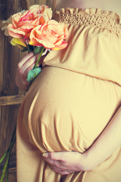 Close up of a cute pregnant belly - Foto, Imagen