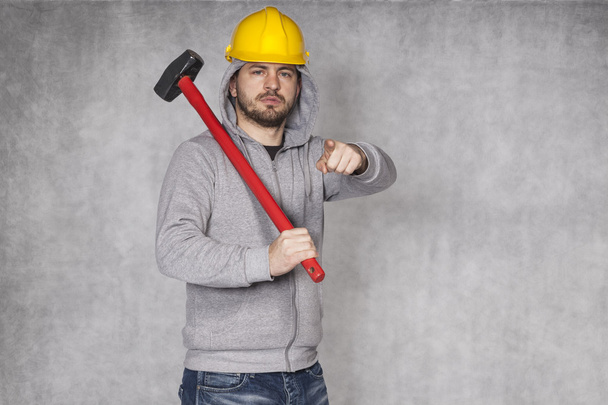 Portrait of a builder who shows you - Foto, immagini