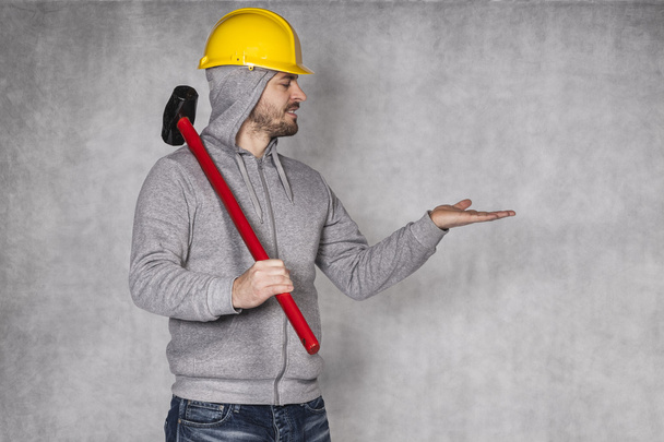 builder on a grey background, space for advertisement - Foto, immagini