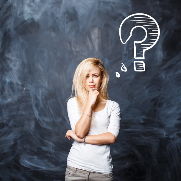 Beautiful blonde Woman with question mark on blackboard - Photo, Image