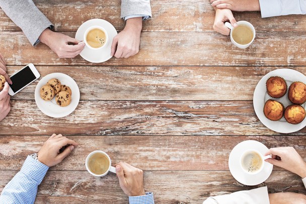 close up of business team drinking coffee on lunch - Photo, image