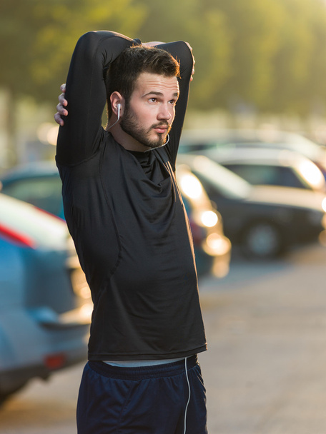 Man stretching outdoors in city before jogging - Foto, Bild