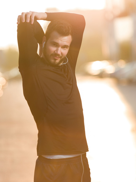Man stretching outdoors in city before jogging - Photo, Image