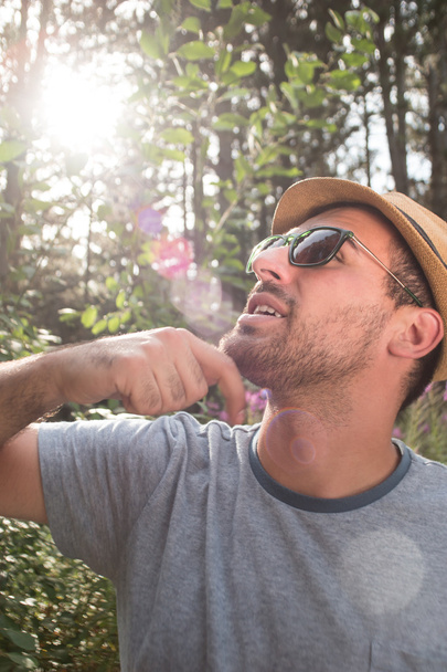 Outdoor lifestyle portrait of young hipster man wearing vintage  - Fotó, kép